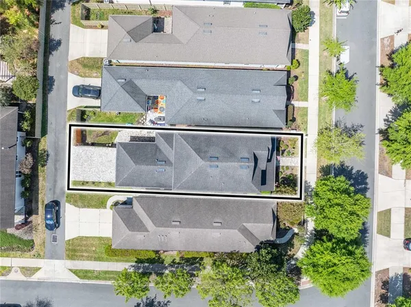 an aerial view of multiple houses with yard