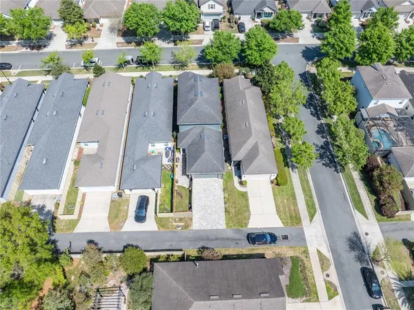 an aerial view of a house with a yard