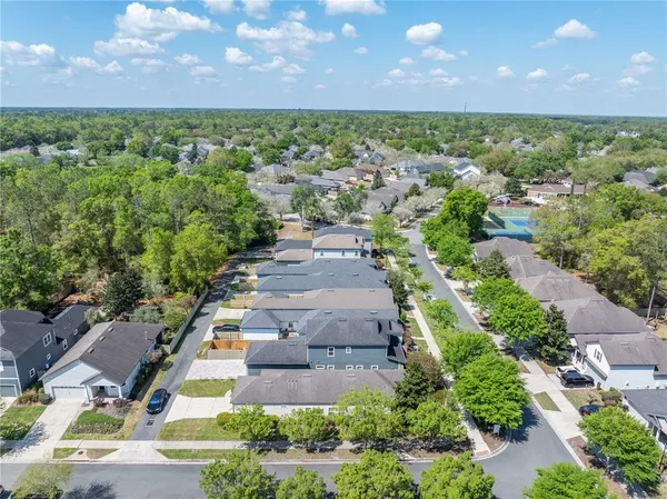 an aerial view of a house with outdoor seating