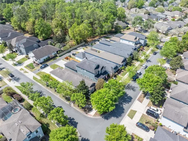 an aerial view of multiple houses with yard