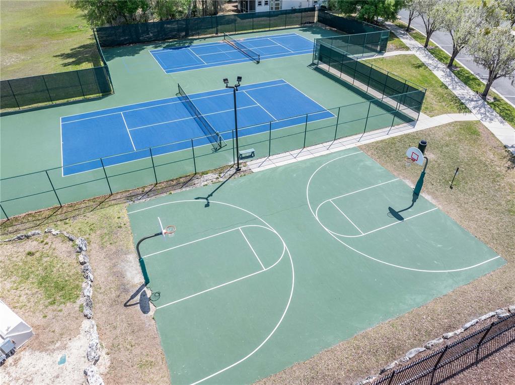 8267 Southwest 78th Lane Gainesville, FL 32608 - Photo 56 of 57 a view of a tennis ground with large trees