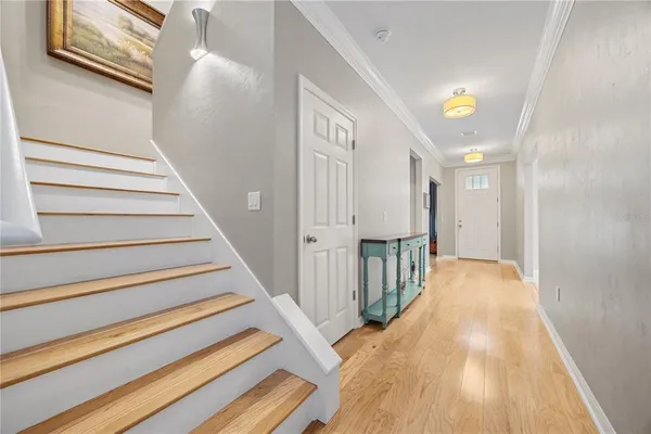 a view of a hallway with wooden floor and entryway