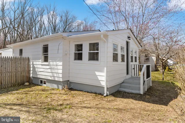 a view of a house with a yard covered in snow