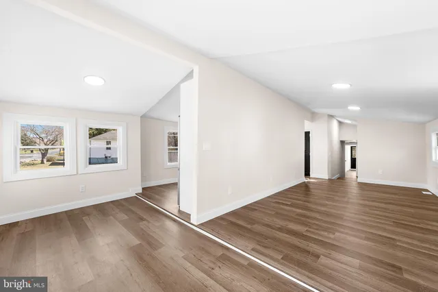 a view of a livingroom with wooden floor and window