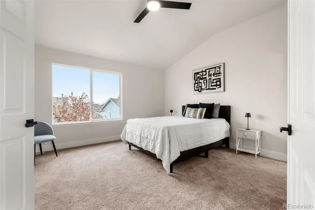 a spacious bedroom with a bed and a chair