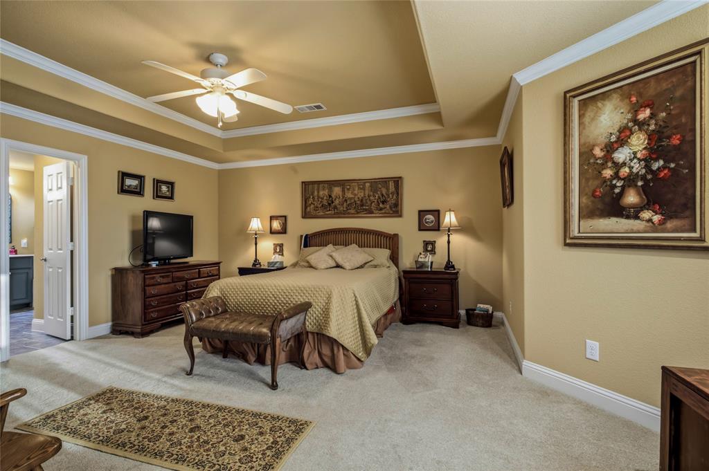 3911 Bennett Road Howe, TX 75459 - Photo 8 of 34 Spacious in square footage and a beautiful ceiling and trim style open this room up! Plenty of space for the bed, but there are area on the right and the left that give you even more room for seating areas and an office.