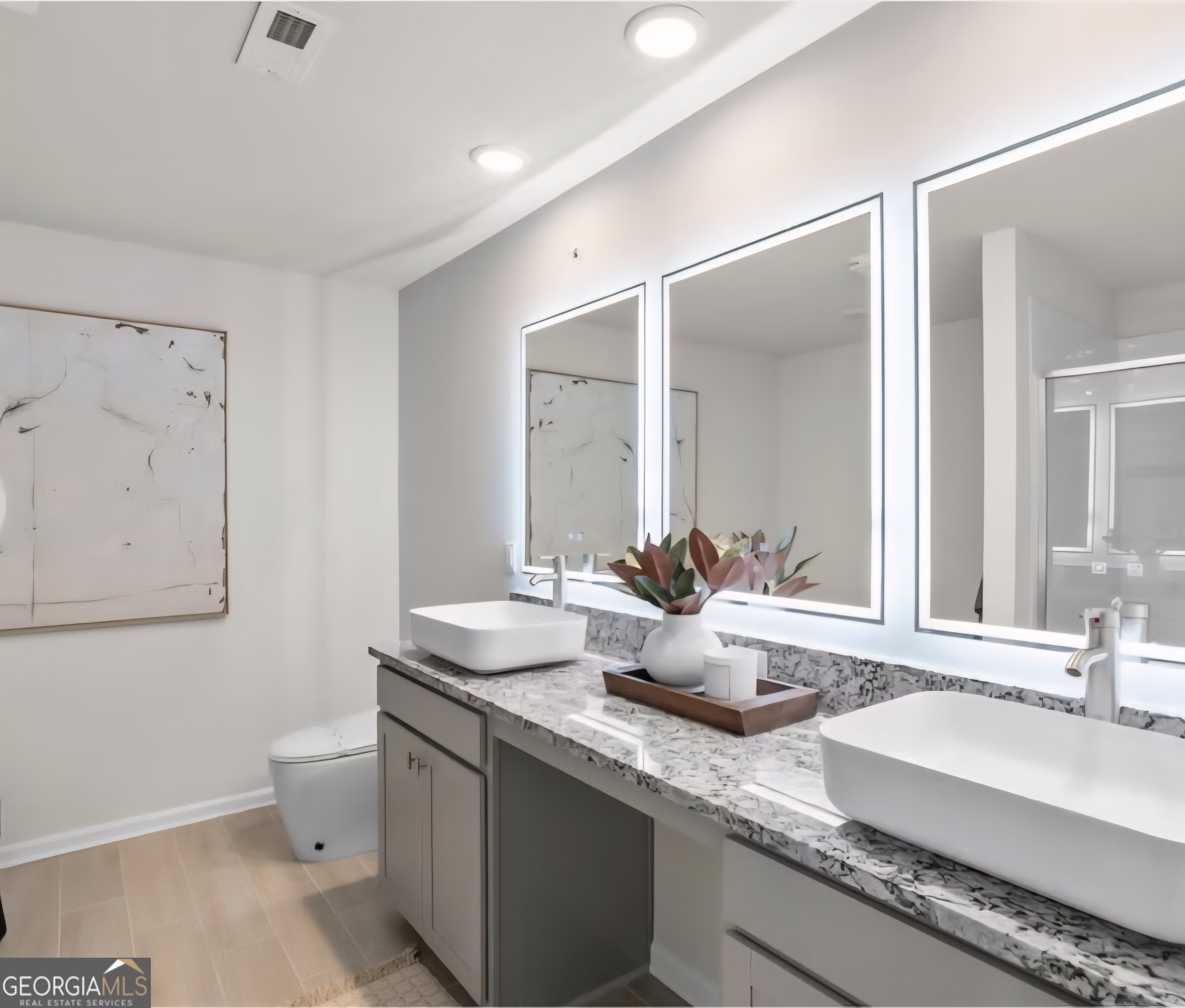11543 Kimberly Way Hampton, GA 30228 - Photo 14 of 15 a bathroom with double vanity sinks a toilet and a mirror