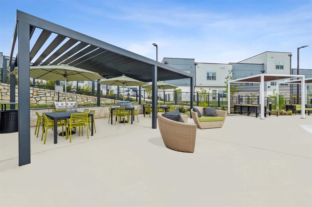 10350 Blue Bluff Road, Unit 1109 Austin, TX 78724 - Photo 23 of 27 a view of a patio with a table and chairs