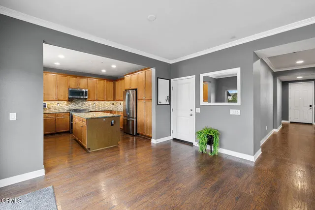 a kitchen with a refrigerator and a stove top oven
