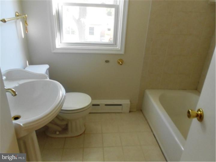 102 Devonshire Road Wilmington, DE 19803 - Photo 2 of 8 a bathroom with a toilet and a tub
