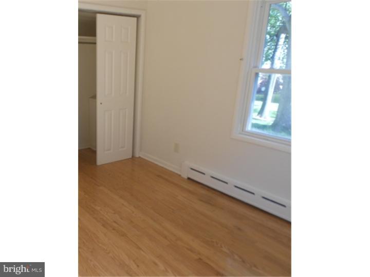 102 Devonshire Road Wilmington, DE 19803 - Photo 3 of 8 a view of an empty room with wooden floor and a window