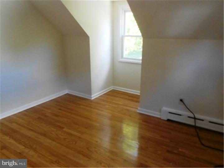 102 Devonshire Road Wilmington, DE 19803 - Photo 5 of 8 an empty room with wooden floor and windows