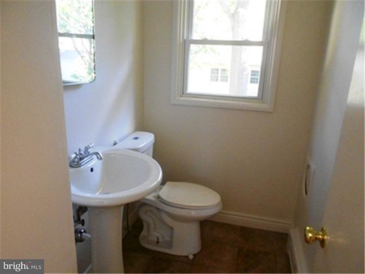 102 Devonshire Road Wilmington, DE 19803 - Photo 8 of 8 a bathroom with a sink a toilet and mirror
