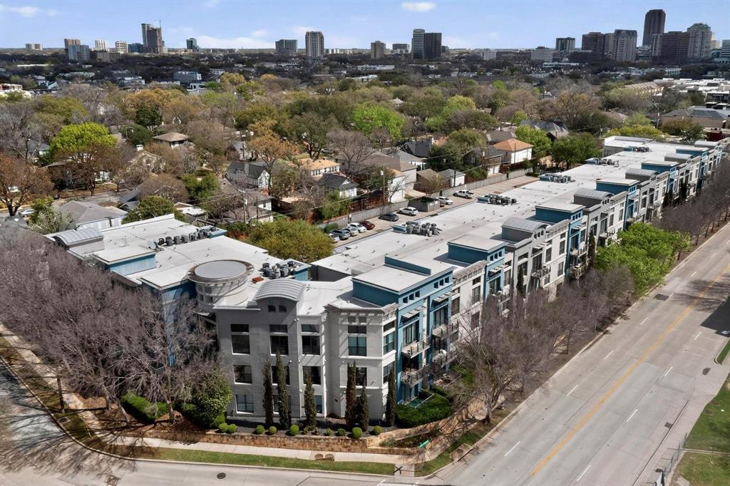 4414 Cedar Springs Road, Unit 318 Dallas, TX 75219 - Photo 12 of 40 Modern multi-story building featuring a gray and blue facade with multiple balconies