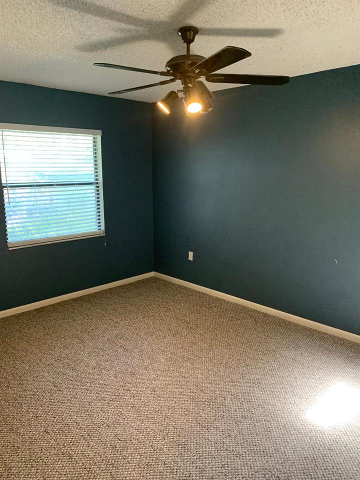 137 Nautilus Road St. Augustine, FL 32086 - Photo 6 of 12 an empty room with a fan and window