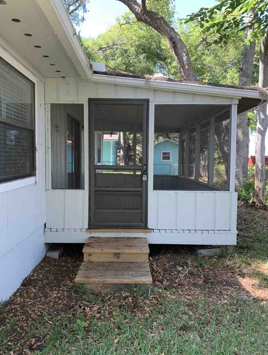 137 Nautilus Road St. Augustine, FL 32086 - Photo 9 of 12 a view of a grey house with a yard