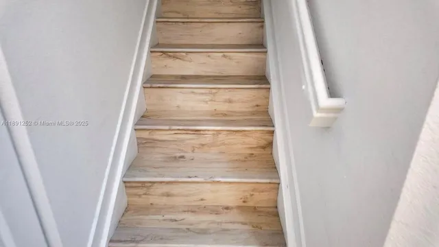 a view of staircase with white walls
