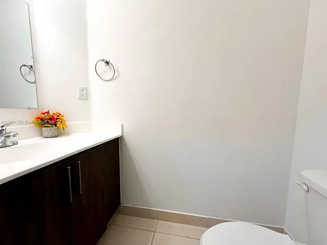 a bathroom with a sink vanity and toilet
