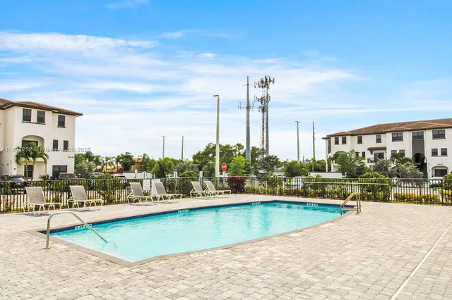 a view of a swimming pool and a chairs