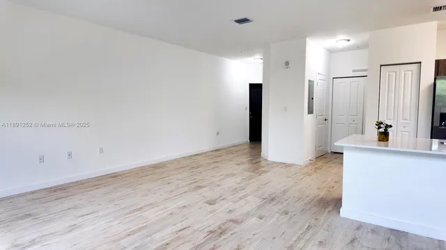 a view of a kitchen with wooden floor