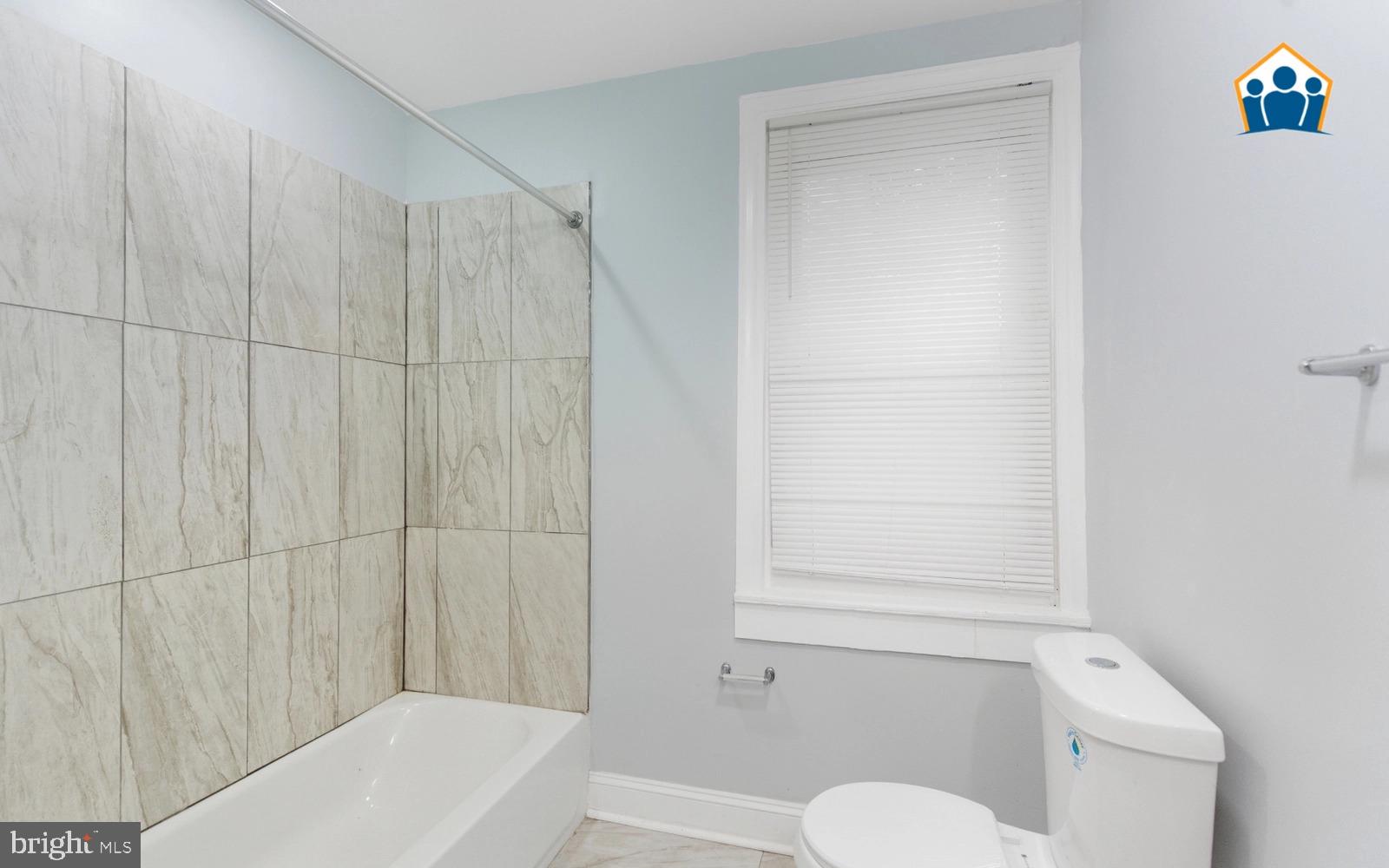 2625 Braddock Street Philadelphia, PA 19125 - Photo 5 of 7 a bathroom with a shower curtain and a toilet