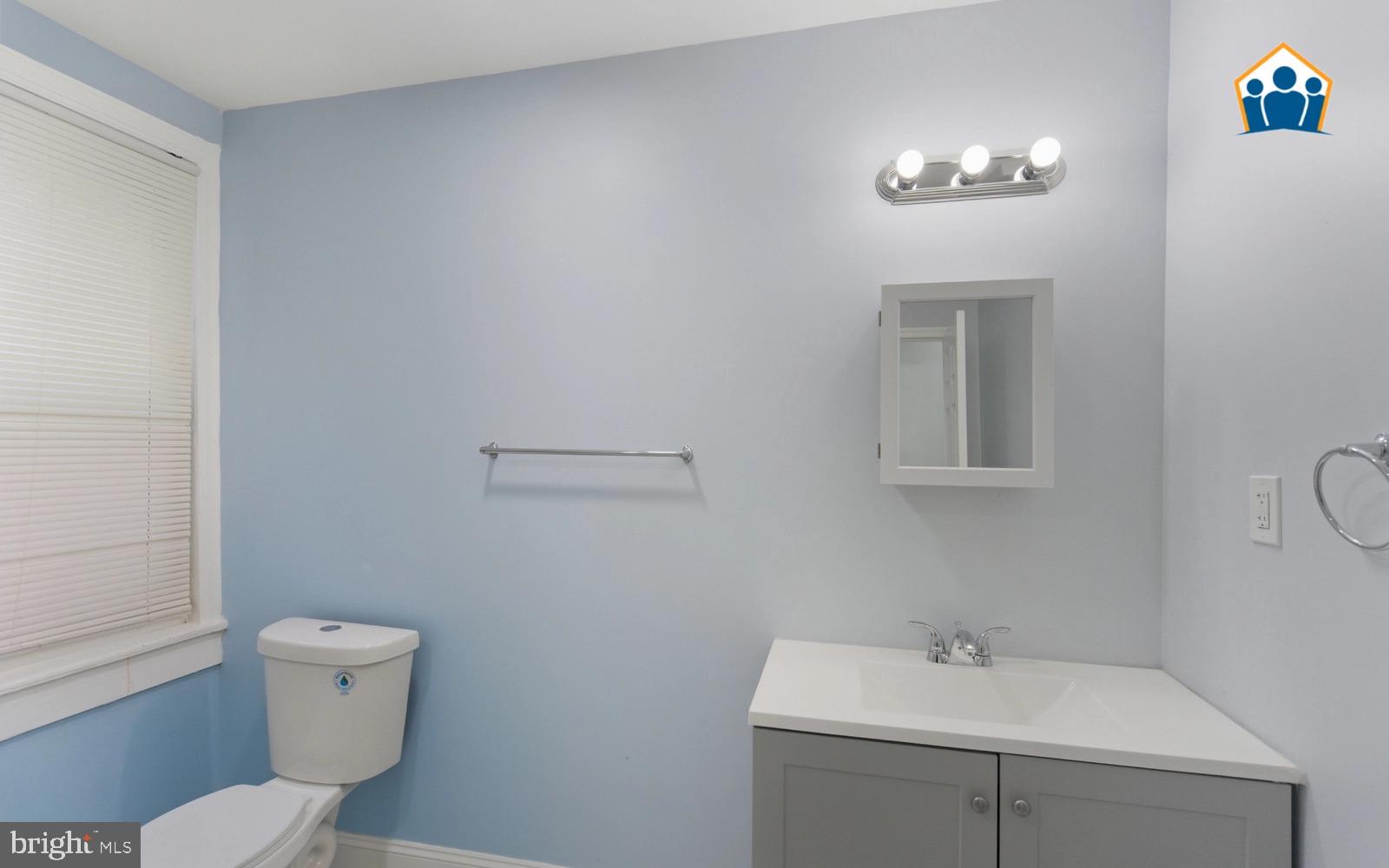 2625 Braddock Street Philadelphia, PA 19125 - Photo 6 of 7 a bathroom with a toilet a sink and mirror
