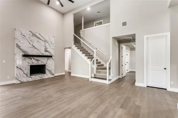 a view of a livingroom with wooden floor and a fireplace