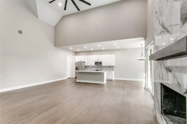 a view of a hallway with a sink and a stove top oven