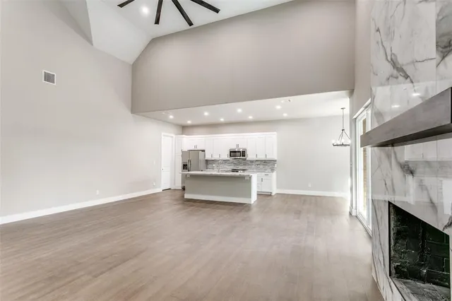 a view of a hallway with a sink and a stove top oven
