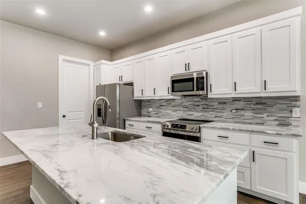 a view of kitchen and kitchen with furniture and fireplace