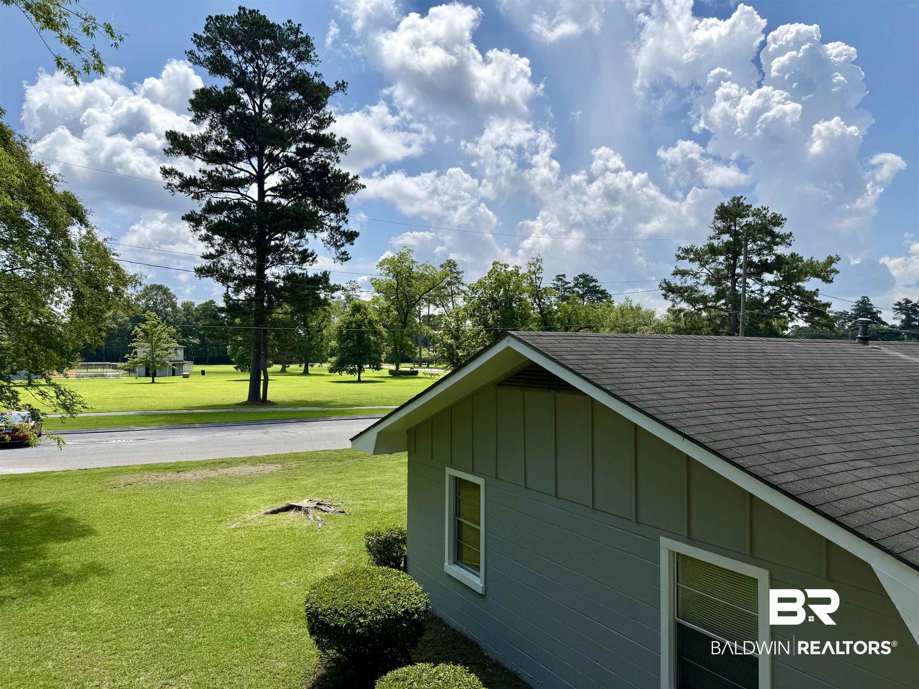 103 Kimberly Street Brewton, AL 36426 - Photo 17 of 18 View of home's exterior with roof with shingles, a lawn, and board and batten siding