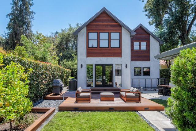 a view of house with yard and outdoor seating