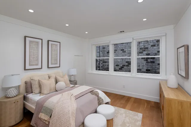 a bed room with a bed and a large window