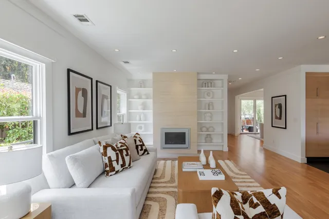a living room with furniture fireplace and flat screen tv