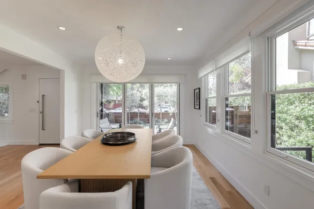 a view of a dining room with furniture large windows and wooden floor