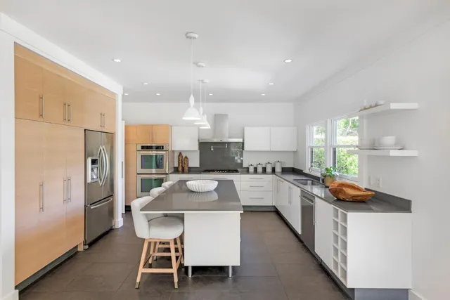 a large kitchen with a table and chairs in it