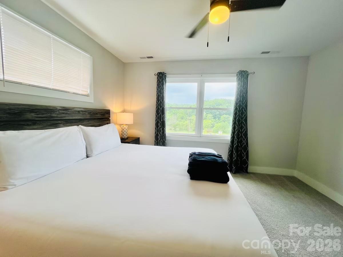 1063 Riverside Drive Asheville, NC 28804 - Photo 15 of 40 a bedroom with a bed and window