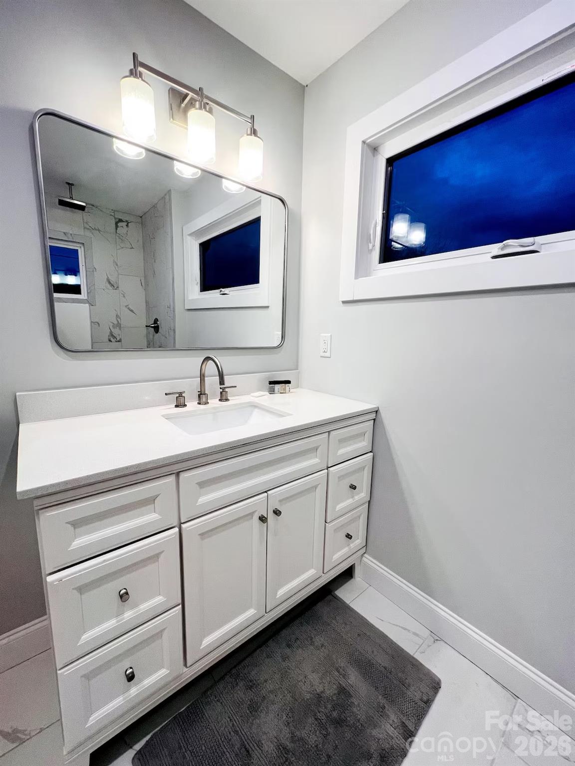 1063 Riverside Drive Asheville, NC 28804 - Photo 24 of 40 a bathroom with a double vanity sink and a mirror
