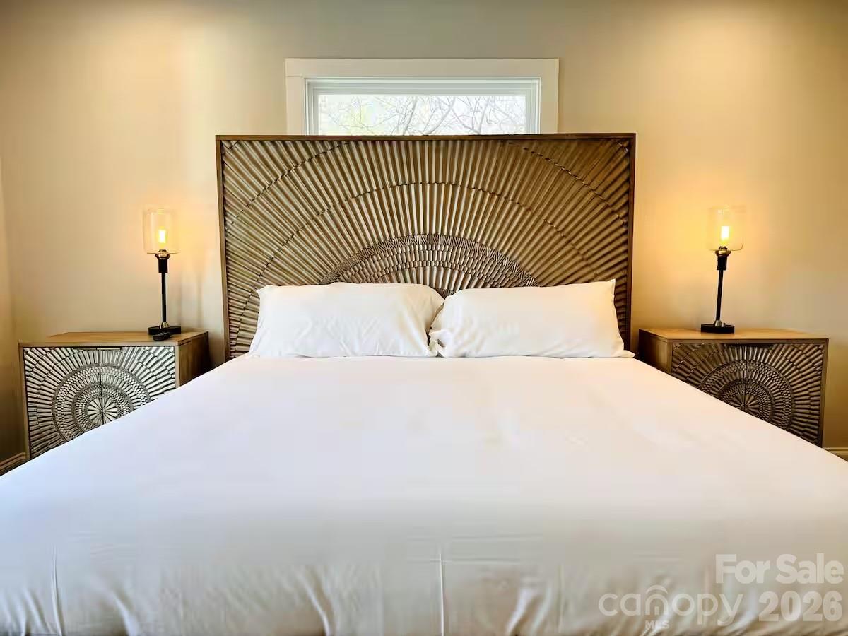 1063 Riverside Drive Asheville, NC 28804 - Photo 26 of 40 a bedroom with a bed and a night stand