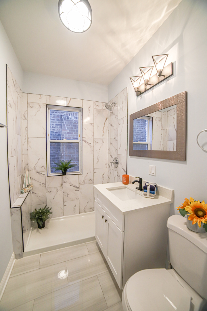 1127 North Ridgeway Avenue Chicago, IL 60651 - Photo 11 of 24 a bathroom with a sink toilet and shower