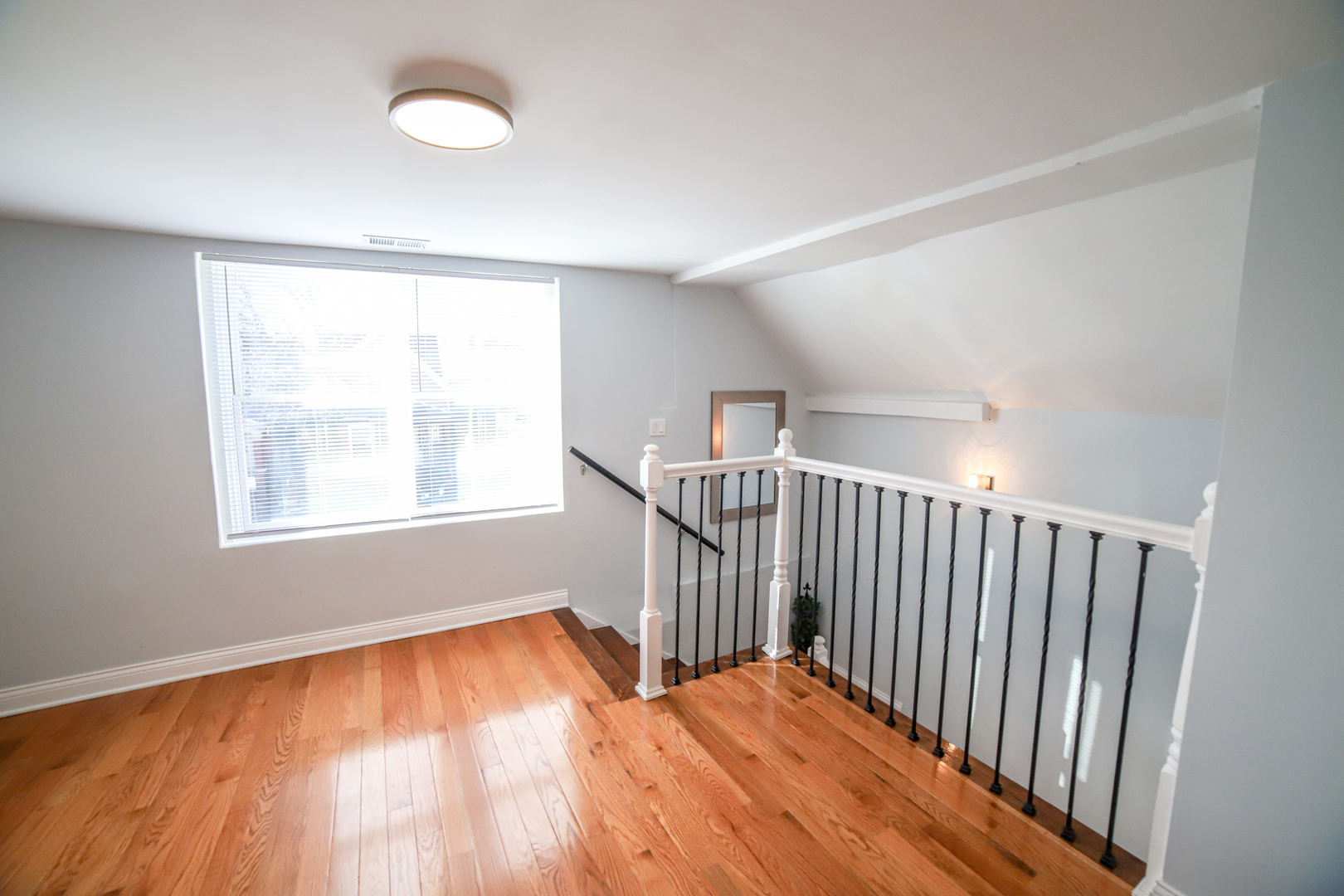 1127 North Ridgeway Avenue Chicago, IL 60651 - Photo 17 of 24 a view of an empty room with wooden floor and a window