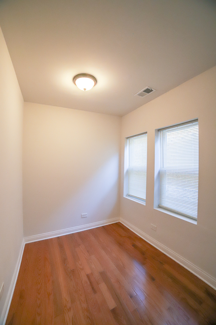1127 North Ridgeway Avenue Chicago, IL 60651 - Photo 19 of 24 an empty room with a window