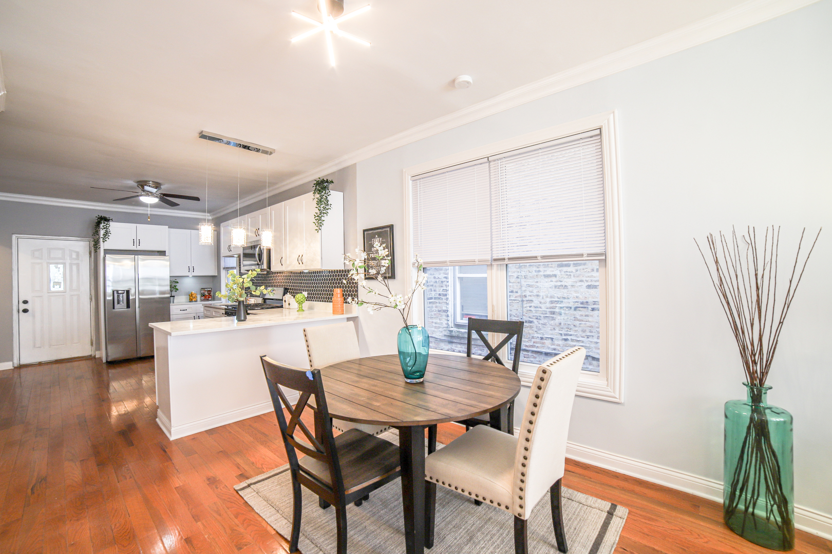 1127 North Ridgeway Avenue Chicago, IL 60651 - Photo 5 of 24 a kitchen with a table and chairs