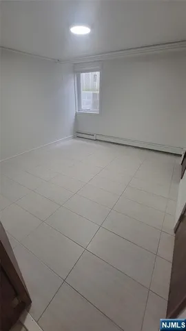 a view of an empty room and a window