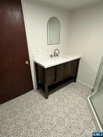 a room with a sink and a mirror
