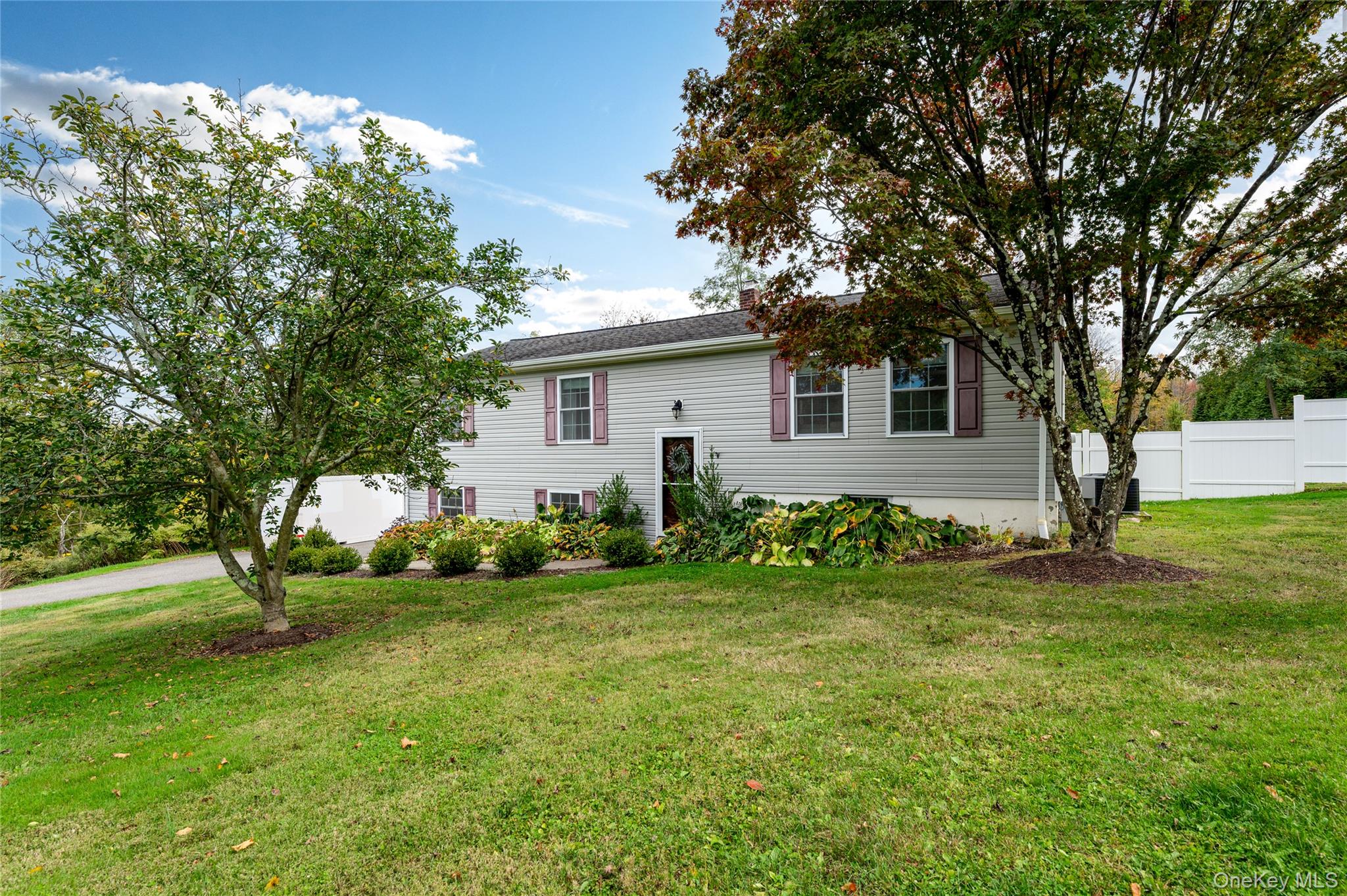 495 Mooney Hill Road Patterson, NY 12563 - Photo 1 of 1 a backyard of a house with plants and large tree