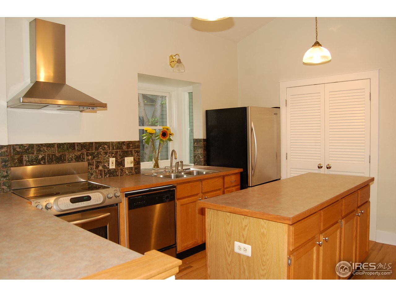 2012 Mapleton Avenue Boulder, CO 80304 - Photo 10 of 14 a kitchen with stainless steel appliances granite countertop a sink and a refrigerator