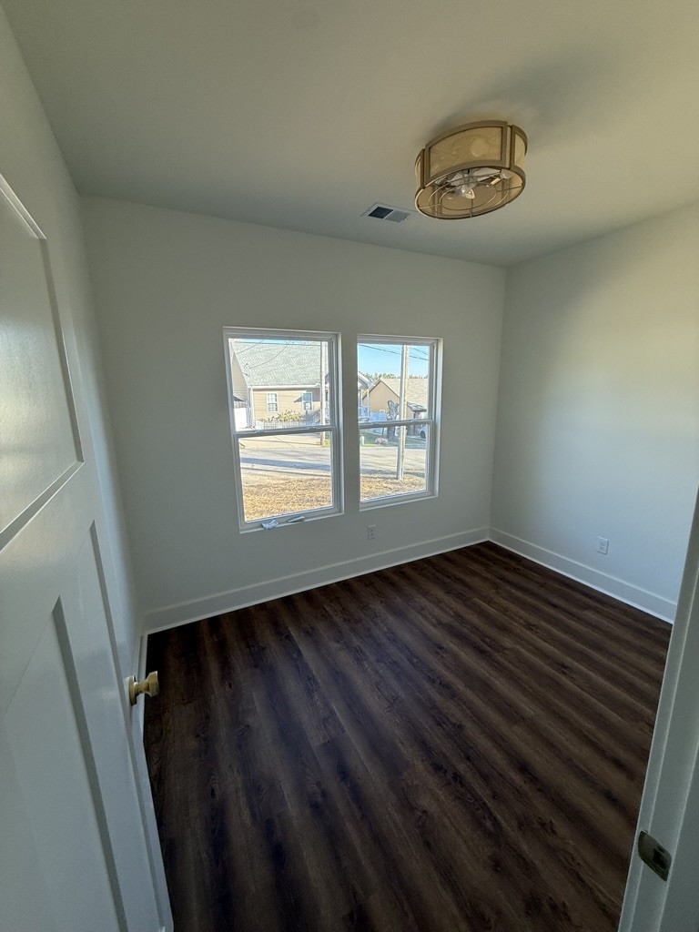 910 East 17th Avenue Springfield, TN 37172 - Photo 12 of 17 a view of an empty room with wooden floor and a window