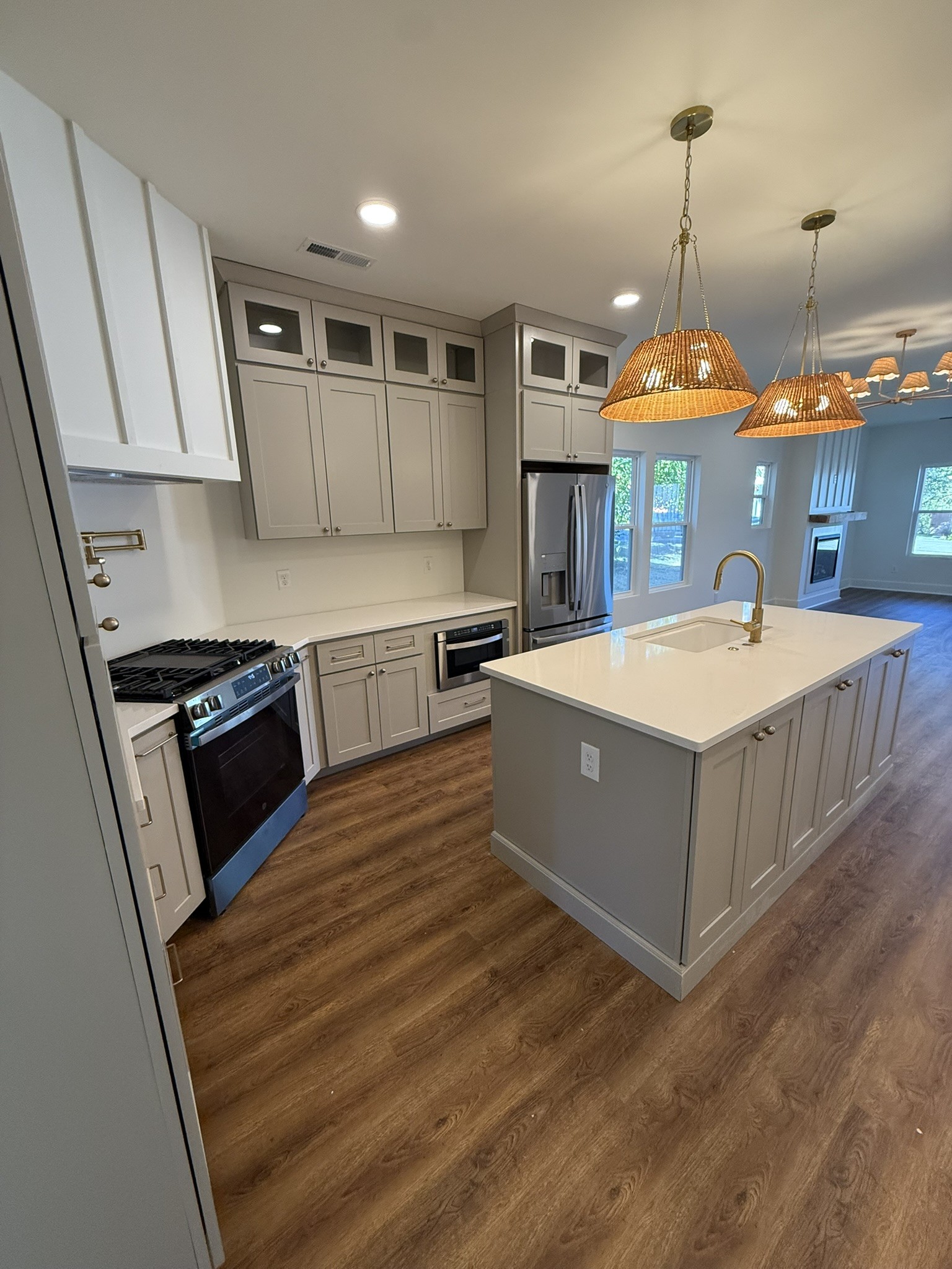 910 East 17th Avenue Springfield, TN 37172 - Photo 5 of 17 a large kitchen with stainless steel appliances granite countertop a sink and dishwasher a stove top oven with wooden floor
