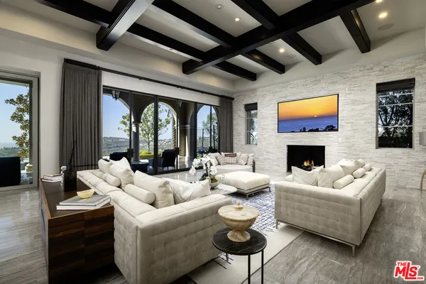 a living room with furniture fireplace and flat screen tv